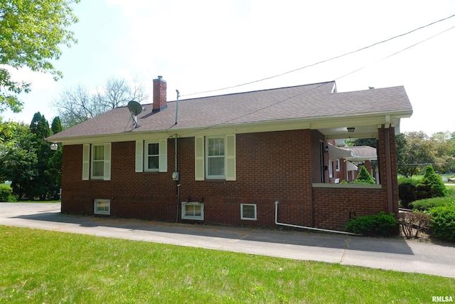 345 Division St, Galesburg, IL 61401 - rear view of property with a chimney, brick siding, a yard, and a shingled roof