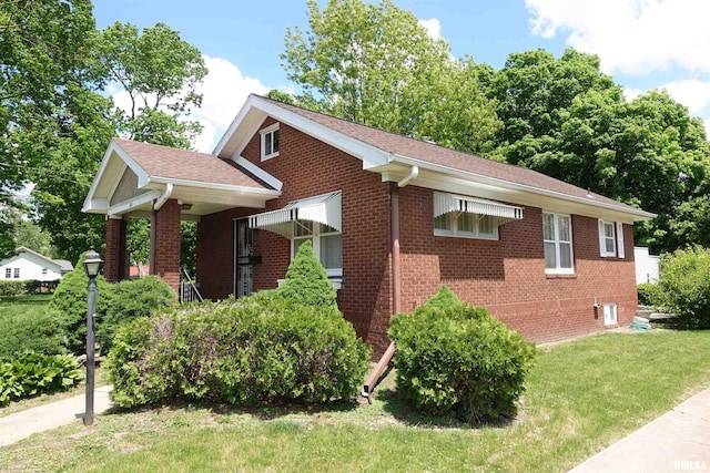 345 Division St, Galesburg, IL 61401 - view of side of home featuring brick siding, a lawn, and a shingled roof