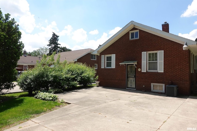 345 Division St, Galesburg, IL 61401 - view of front facade with brick siding, a chimney, and cooling unit