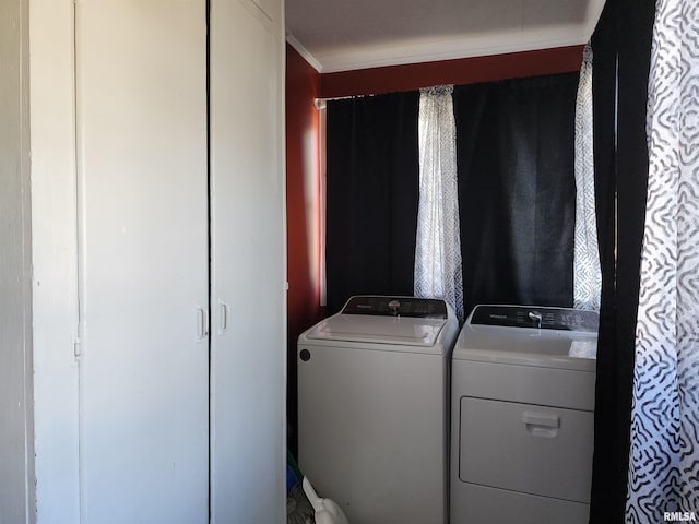 laundry room with washer and clothes dryer and ornamental molding