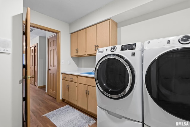 5021 Wildcat Run, Springfield, IL 62711 - washroom featuring washer and clothes dryer, cabinet space, and wood finished floors