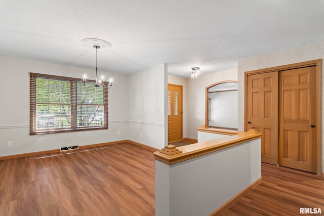 5021 Wildcat Run, Springfield, IL 62711 - unfurnished room featuring a chandelier, wood finished floors, and baseboards