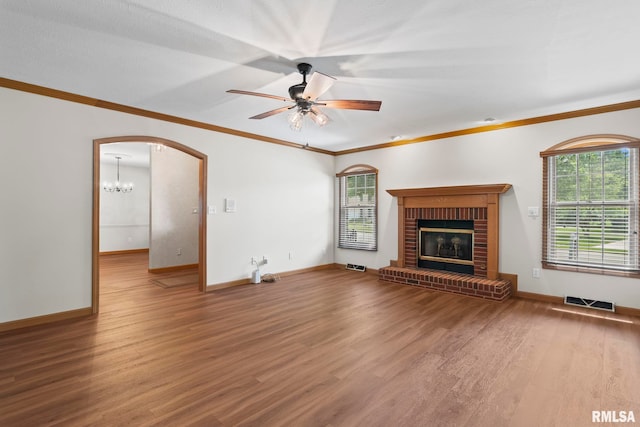 5021 Wildcat Run, Springfield, IL 62711 - unfurnished living room with wood finished floors, healthy amount of natural light, a ceiling fan, crown molding, and a fireplace