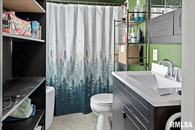 bathroom featuring toilet, vanity, a shower with curtain, and tile patterned floors
