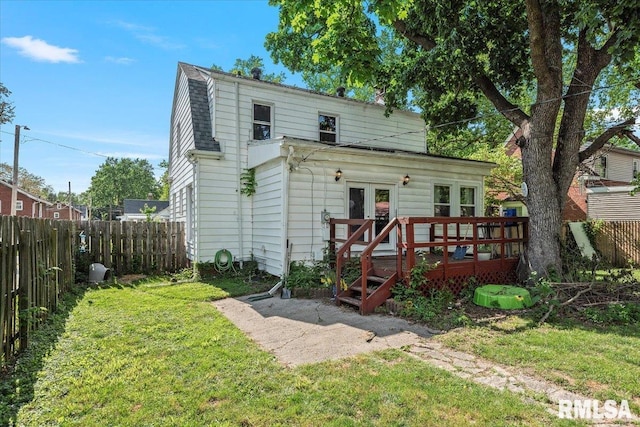 back of property featuring a wooden deck and french doors