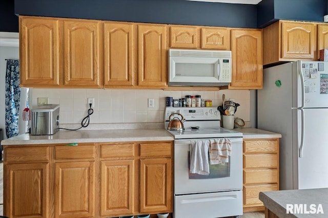kitchen with white appliances, tasteful backsplash, and light countertops