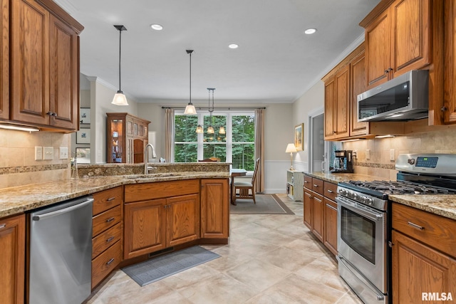 1625 Grace Ridge Rd, New Berlin, IL 62670 - kitchen with appliances with stainless steel finishes, a sink, ornamental molding, brown cabinetry, and a peninsula