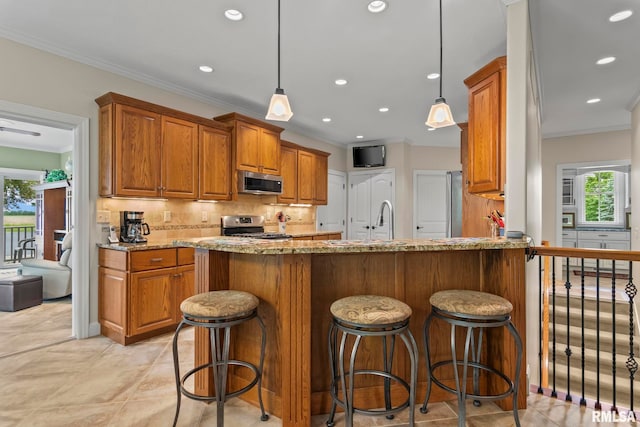 1625 Grace Ridge Rd, New Berlin, IL 62670 - kitchen featuring appliances with stainless steel finishes, ornamental molding, brown cabinets, light stone countertops, and tasteful backsplash