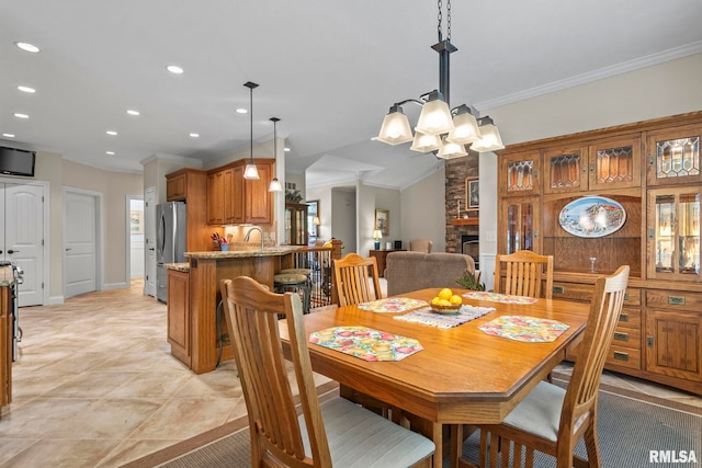 1625 Grace Ridge Rd, New Berlin, IL 62670 - dining room with crown molding, a chandelier, recessed lighting, and a stone fireplace