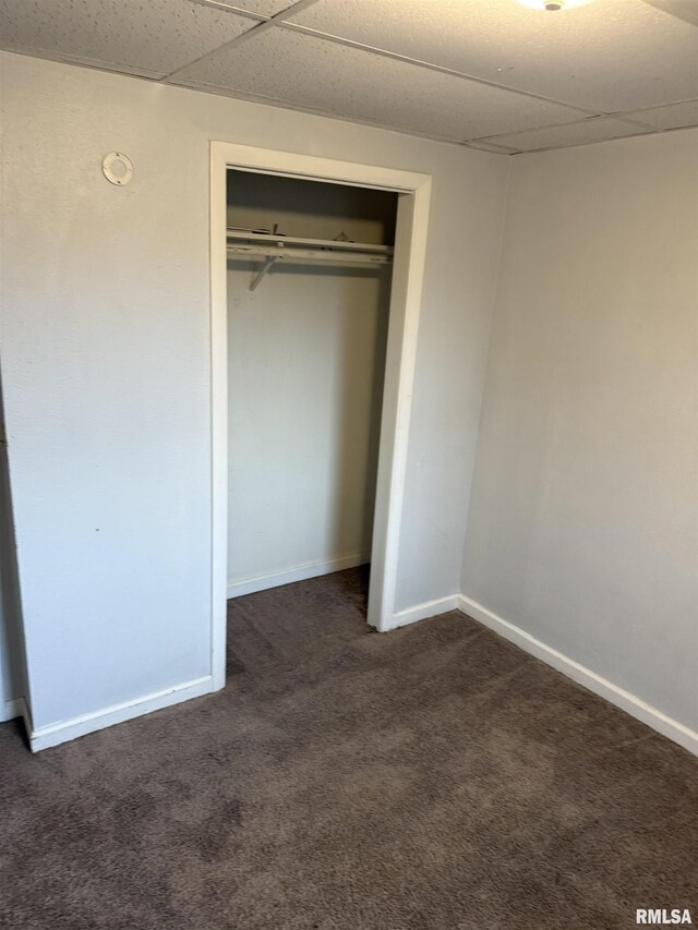 1205 E Converse Ave, Springfield, IL 62702 - unfurnished bedroom with dark colored carpet, a paneled ceiling, baseboards, and a closet
