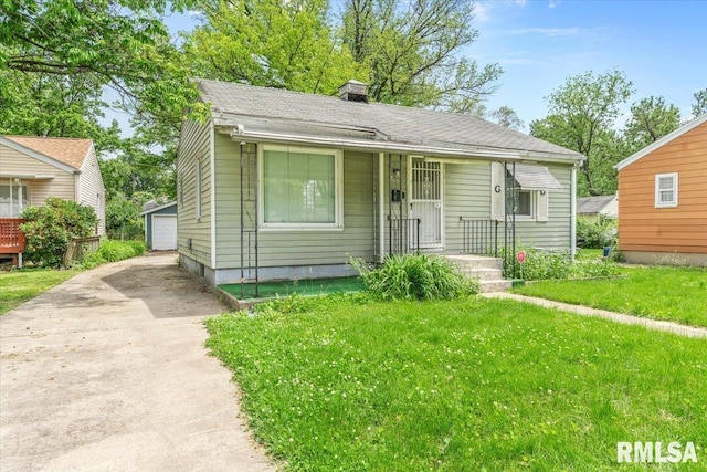 1816 S Street Ct, Springfield, IL 62703 - bungalow-style house featuring an outbuilding, a chimney, a front yard, and a garage