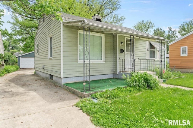 1816 S Street Ct, Springfield, IL 62703 - bungalow featuring an outbuilding, a chimney, a detached garage, and a porch