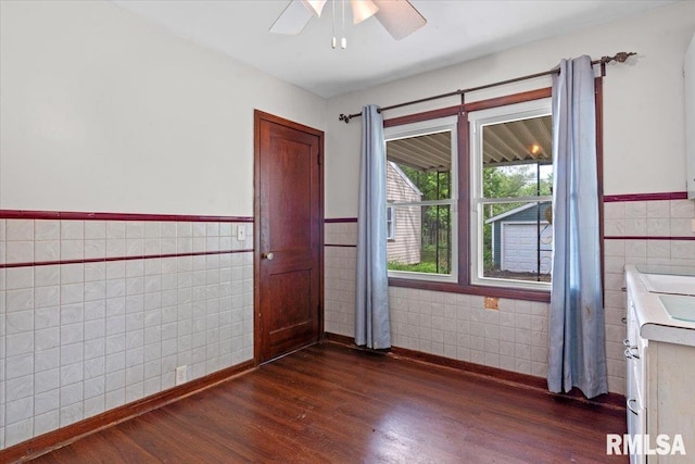 1816 S Street Ct, Springfield, IL 62703 - unfurnished room featuring tile walls, wainscoting, dark wood-style floors, and a ceiling fan