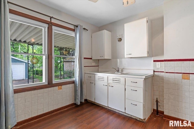 1816 S Street Ct, Springfield, IL 62703 - kitchen with tile walls, dark wood-style floors, light countertops, white cabinetry, and a sink