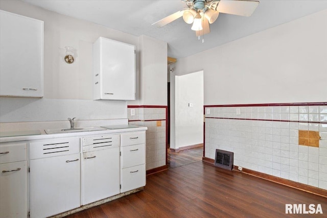 1816 S Street Ct, Springfield, IL 62703 - kitchen with tile walls, a sink, light countertops, dark wood-type flooring, and white cabinets