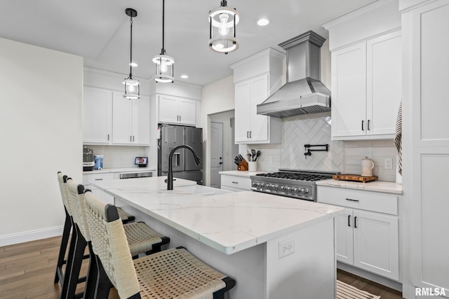1915 Parthenon Ct, Chatham, IL 62629 - kitchen featuring wall chimney range hood, freestanding refrigerator, wood finished floors, recessed lighting, and range