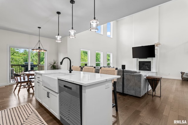 1915 Parthenon Ct, Chatham, IL 62629 - kitchen featuring dishwasher, a sink, dark wood-style flooring, white cabinets, and an island with sink