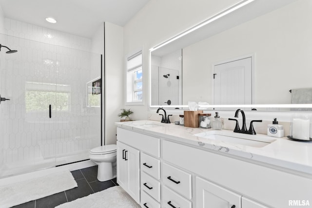 1915 Parthenon Ct, Chatham, IL 62629 - bathroom featuring a stall shower, toilet, double vanity, and tile patterned floors