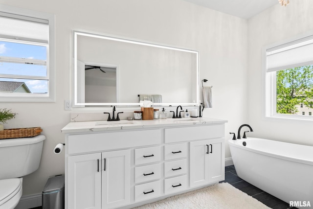 1915 Parthenon Ct, Chatham, IL 62629 - bathroom with toilet, double vanity, a freestanding bath, and tile patterned flooring