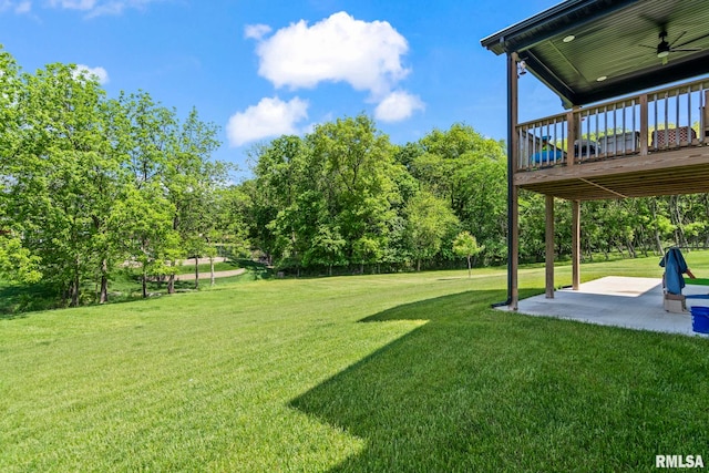 1915 Parthenon Ct, Chatham, IL 62629 - view of green lawn featuring a patio area, a ceiling fan, a wooden deck, and view of scattered trees