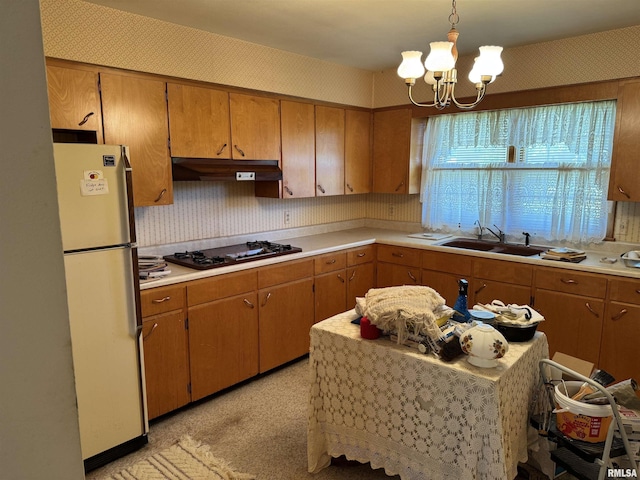 845 E Main St, Havana, IL 62644 - kitchen with a sink, under cabinet range hood, freestanding refrigerator, and light countertops