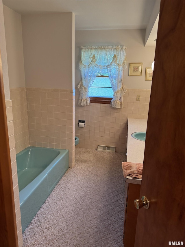 845 E Main St, Havana, IL 62644 - full bathroom featuring vanity, a bath, tile walls, toilet, and a wainscoted wall