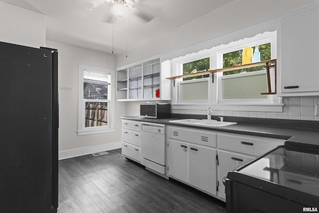 kitchen featuring black appliances, a sink, dark countertops, open shelves, and plenty of natural light