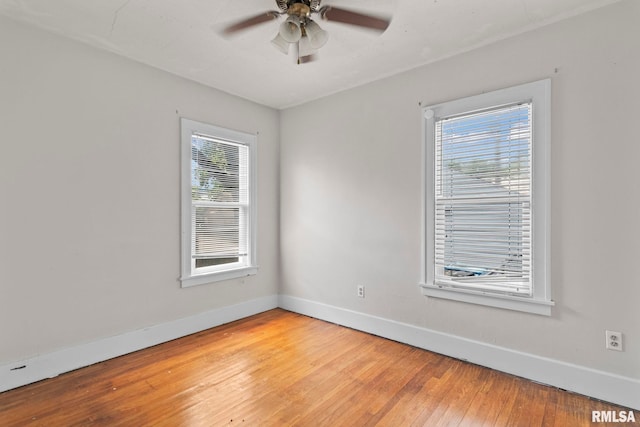 unfurnished room with baseboards, light wood-style flooring, plenty of natural light, and ceiling fan