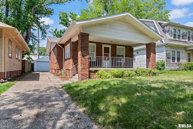 view of front of home featuring covered porch, an outdoor structure, a garage, a front lawn, and brick siding