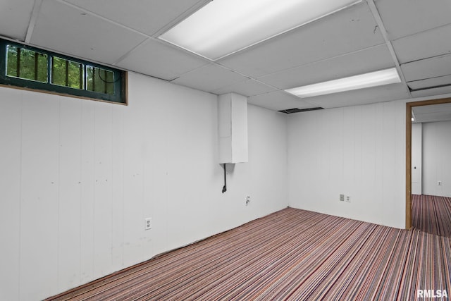 basement with wood walls and carpet flooring