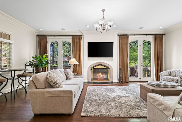 living room with crown molding, a chandelier, wood finished floors, a fireplace with flush hearth, and recessed lighting