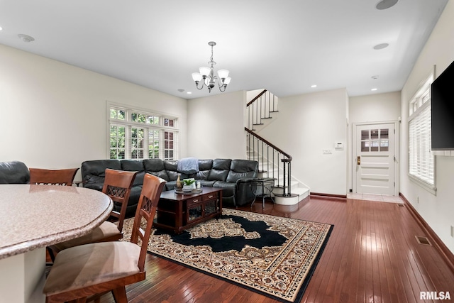 living area featuring a chandelier, wood-type flooring, stairway, baseboards, and recessed lighting
