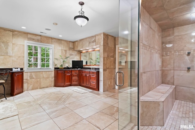 full bath with tile walls, a shower stall, tile patterned flooring, vanity, and recessed lighting
