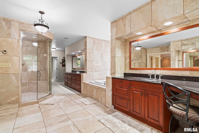 full bathroom featuring a stall shower, a bath, tile patterned flooring, and vanity