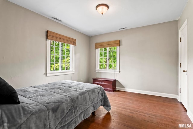 bedroom featuring wood finished floors and baseboards