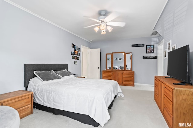 bedroom featuring light carpet, ornamental molding, baseboards, and a ceiling fan