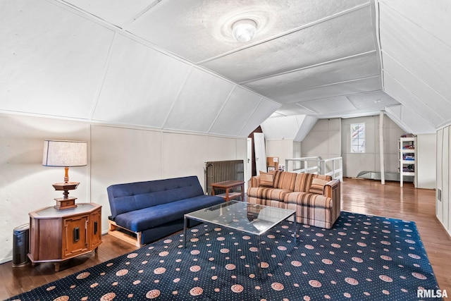 sitting room featuring wood finished floors and lofted ceiling