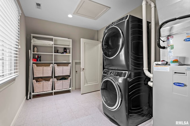 washroom with stacked washing machine and dryer, attic access, baseboards, and recessed lighting