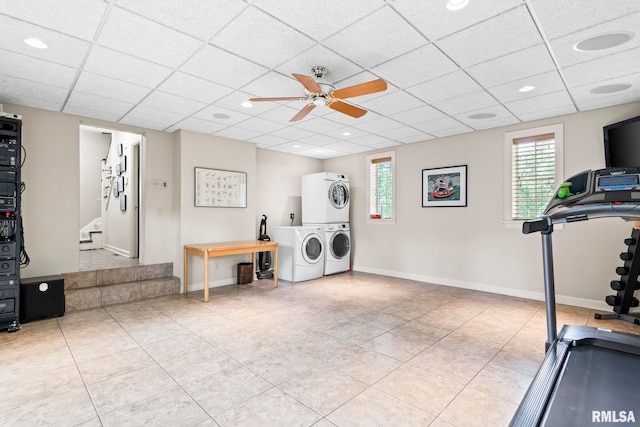 workout room featuring stacked washing machine and dryer, a drop ceiling, tile patterned flooring, a ceiling fan, and recessed lighting