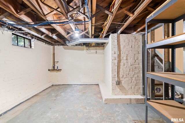 below grade area featuring brick wall