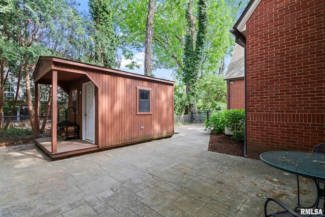 view of patio with fence and an outdoor structure