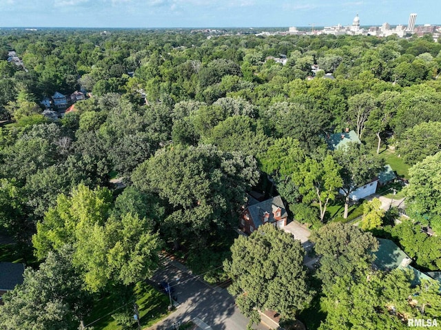 aerial view of property's location featuring a forest
