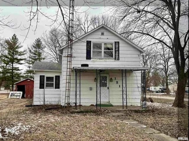 bungalow-style home featuring an outbuilding