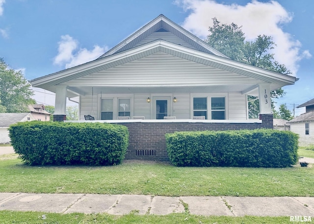 103 N Ohio Ave, Abingdon, IL 61410 - view of front of home featuring a front lawn, covered porch, and brick siding