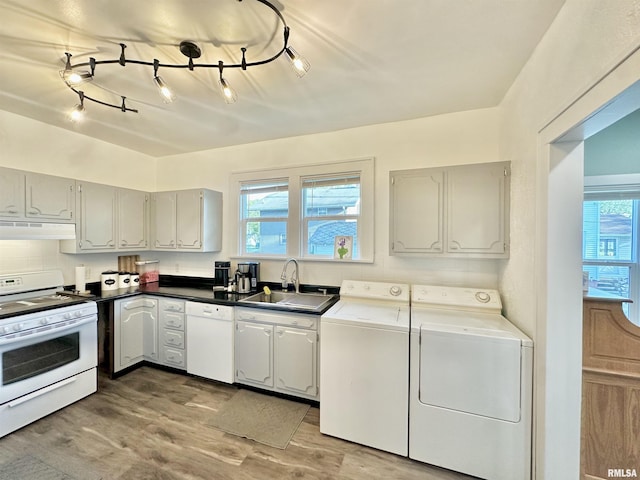 103 N Ohio Ave, Abingdon, IL 61410 - kitchen with white appliances, a sink, under cabinet range hood, washer and dryer, and light wood finished floors