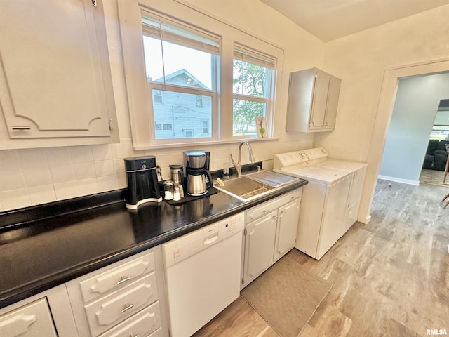 103 N Ohio Ave, Abingdon, IL 61410 - kitchen with white dishwasher, a sink, light wood-type flooring, separate washer and dryer, and tasteful backsplash