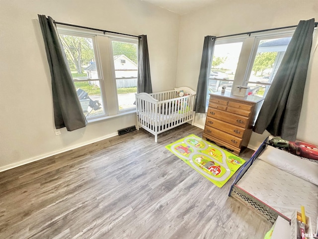 103 N Ohio Ave, Abingdon, IL 61410 - bedroom featuring wood finished floors, baseboards, and a nursery area