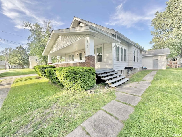 103 N Ohio Ave, Abingdon, IL 61410 - view of front of property with a porch, a front lawn, and brick siding