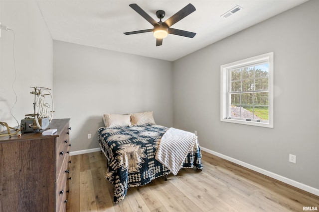 142 Oak Rd, Harrisburg, IL 62946 - bedroom featuring baseboards, wood finished floors, and ceiling fan
