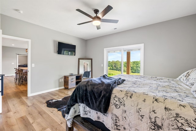 142 Oak Rd, Harrisburg, IL 62946 - bedroom featuring light wood finished floors, baseboards, access to exterior, and ceiling fan